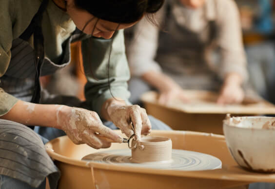 Woman creating pottery represents balance with medication.