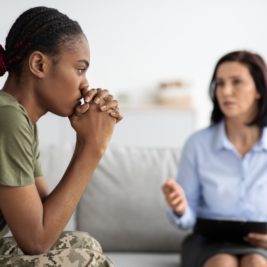 A veteran woman with PTSD getting treated with a therapist