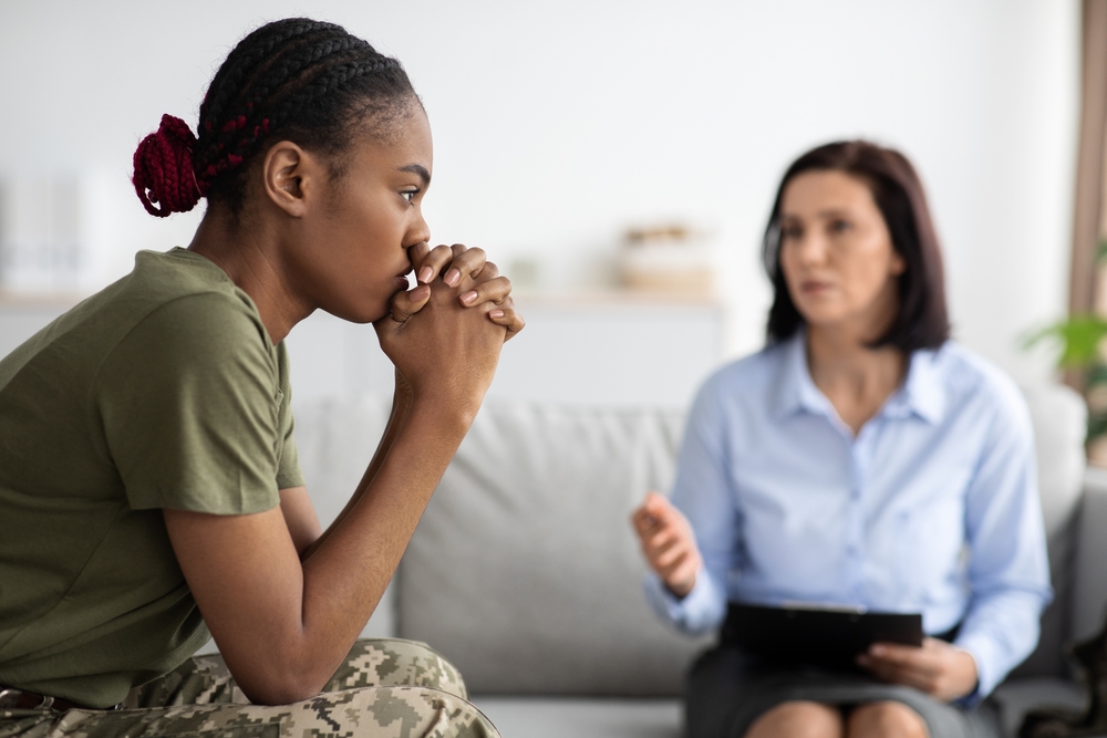 A veteran woman with PTSD getting treated with a therapist